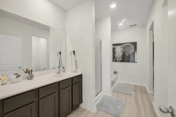 a spacious bathroom with a double vanity sink and a mirror