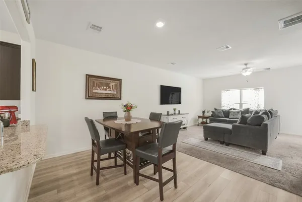 a living room with furniture a rug and a flat screen tv