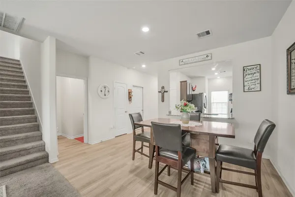 a dining room with furniture and wooden floor