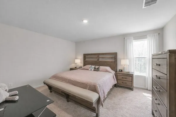 a bedroom with a bed and a window