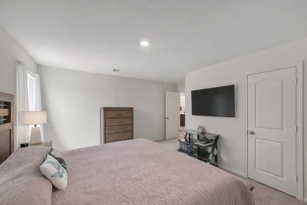 a bedroom with a bed and a flat screen tv