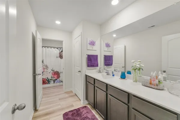 a bathroom with a sink mirror and vanity