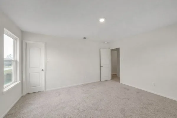 a view of a house with backyard and a tree