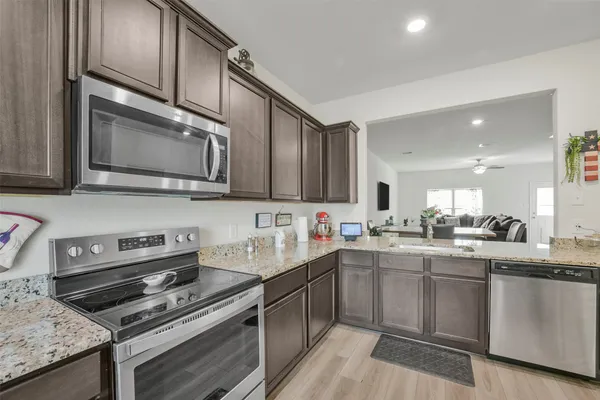 a kitchen with stainless steel appliances a sink stove and cabinets
