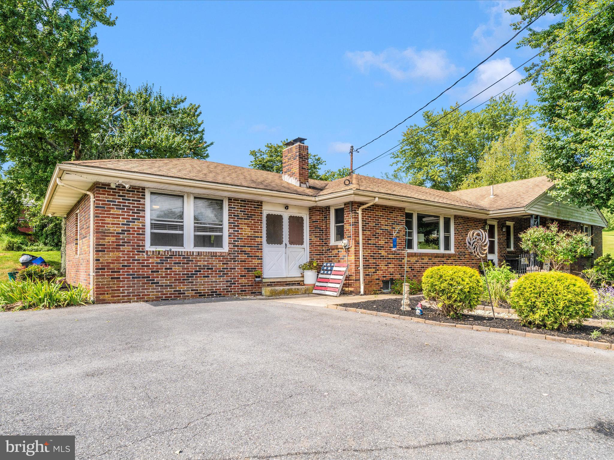a front view of a house with a garden and porch