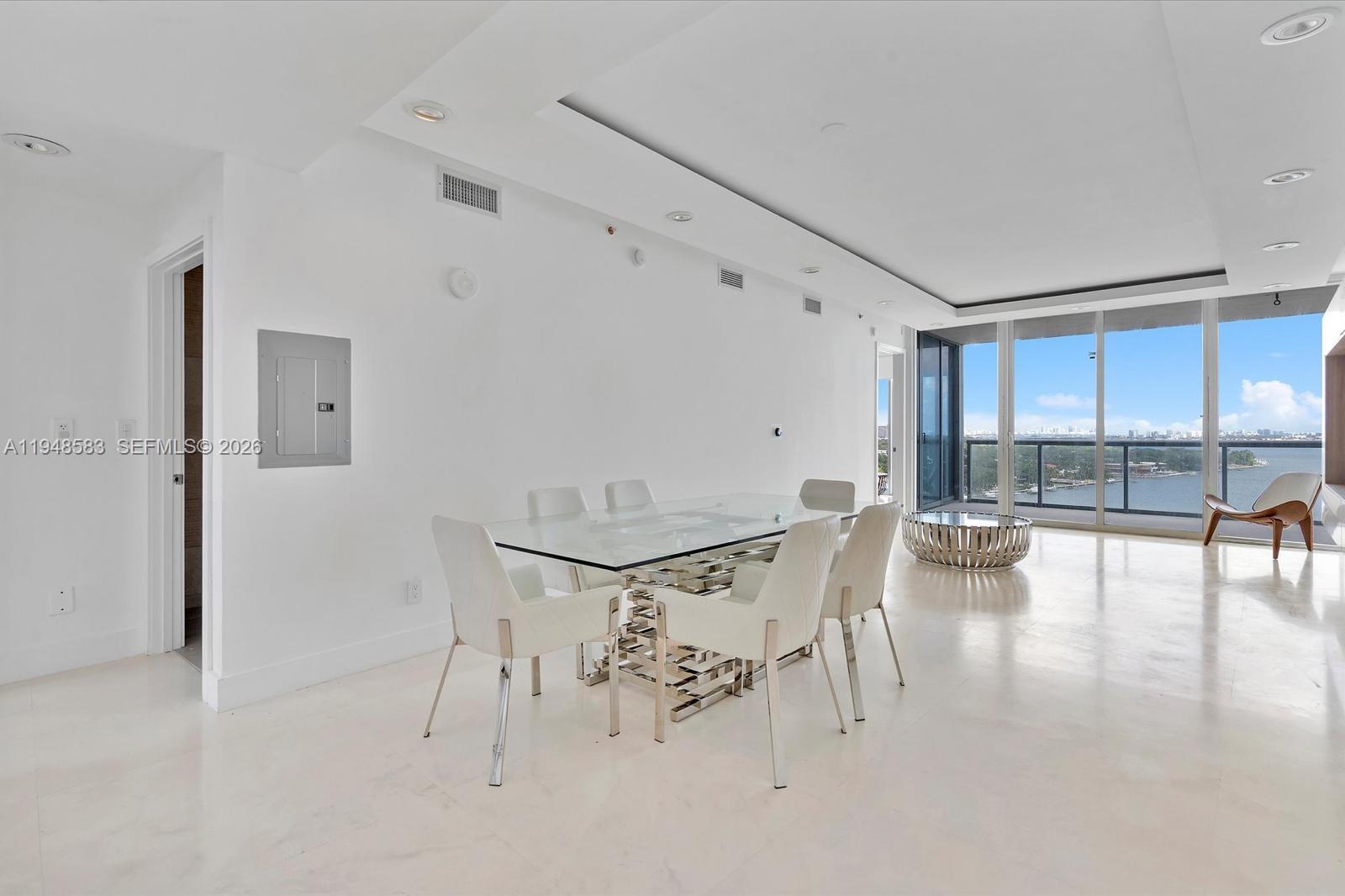 601 Northeast 36th Street, Unit 1310 Miami, FL 33137 - Photo 12 of 40 a view of a dining room with furniture and wooden floor
