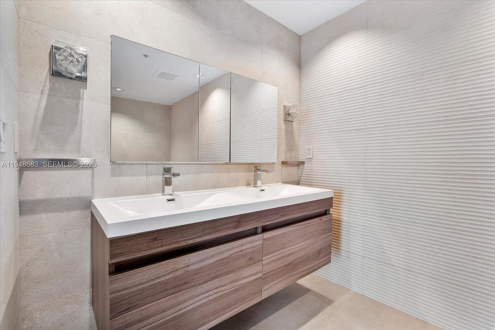 601 Northeast 36th Street, Unit 1310 Miami, FL 33137 - Photo 15 of 40 a bathroom with a sink and a mirror