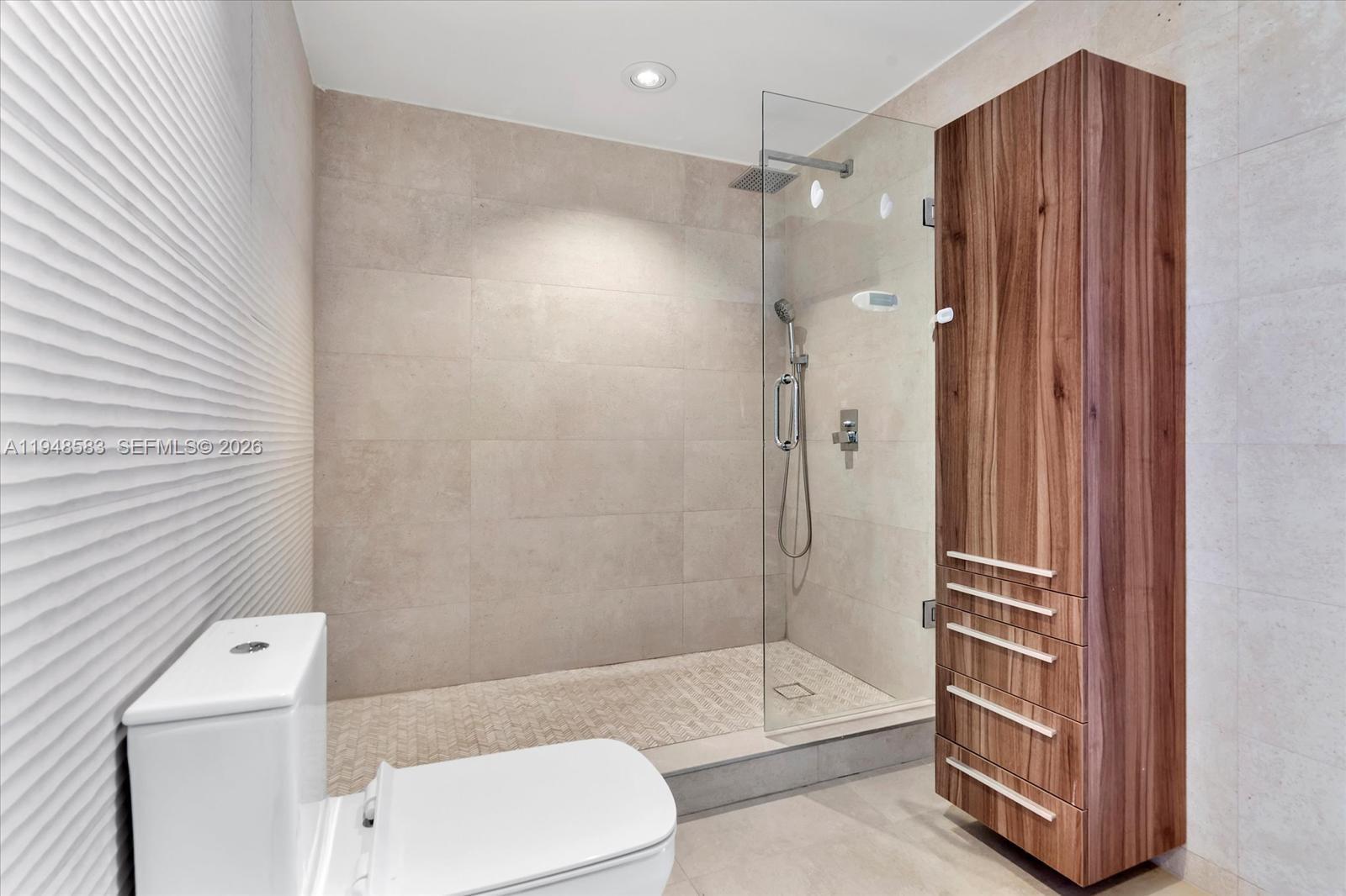 601 Northeast 36th Street, Unit 1310 Miami, FL 33137 - Photo 19 of 40 a bathroom with a shower and a toilet