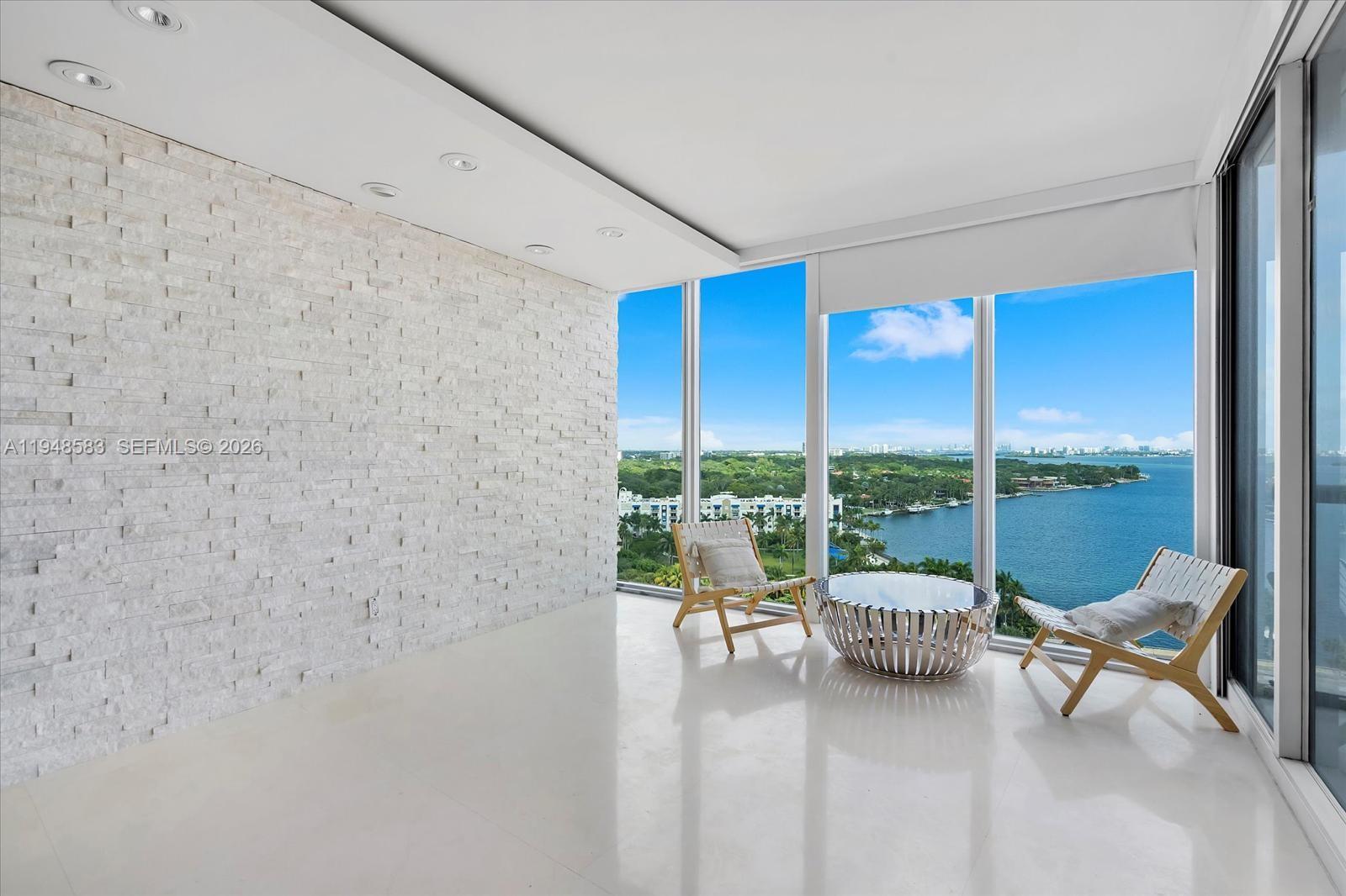 601 Northeast 36th Street, Unit 1310 Miami, FL 33137 - Photo 2 of 40 a living room with furniture and a floor to ceiling window
