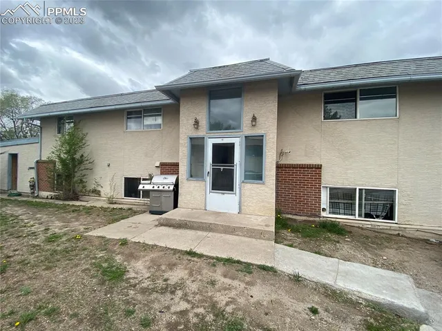 a front view of a house with yard and glass windows