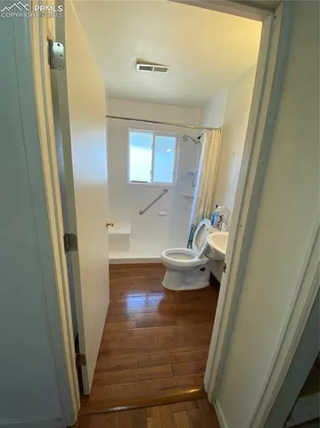 a view of bathroom with bathtub and door