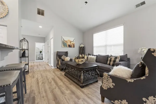 a living room with furniture and a wooden floor