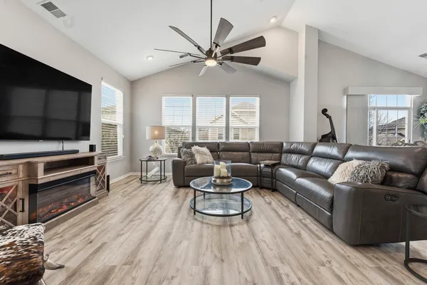 a living room with furniture and a chandelier