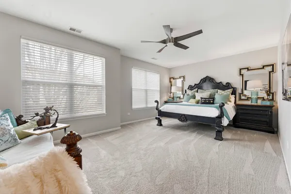 a bedroom with a bed and a chandelier