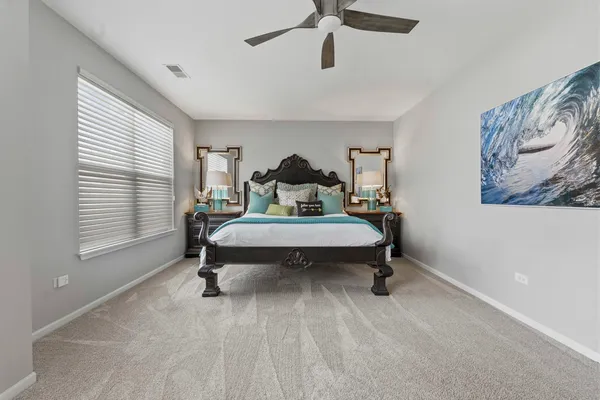 a bedroom with a bed a desk and a couch