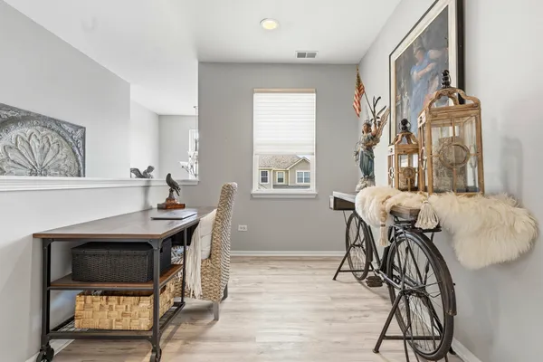 a dining room with furniture and a wooden floor
