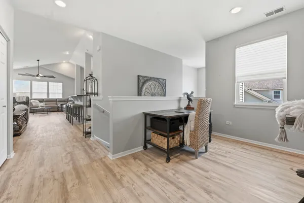 a living room with lots of furniture and kitchen view