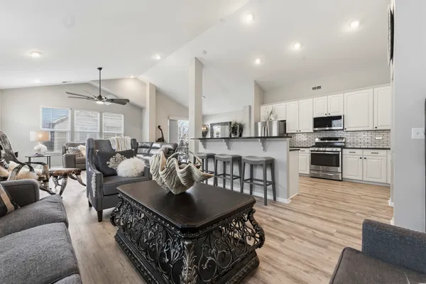 a living room with furniture and a kitchen