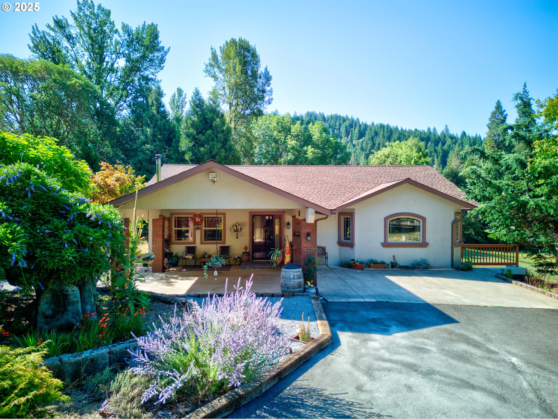 913 Starveout Creek Road Azalea, OR 97410 - Photo 2 of 27 a front view of a house with a yard and trees