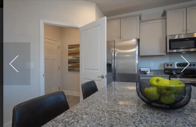 a view of a kitchen with a sink and dishwasher a refrigerator with wooden floor