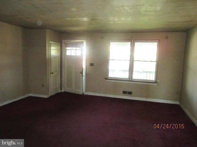 1909 Barry Road Baltimore, MD 21222 - Photo 3 of 12 wooden floor in an empty room with a window