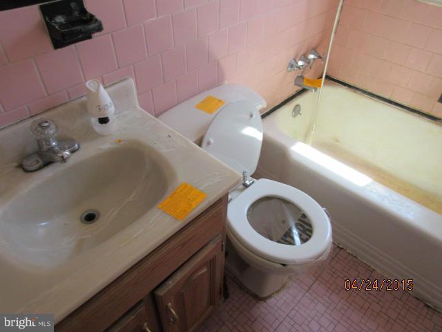 1909 Barry Road Baltimore, MD 21222 - Photo 8 of 12 a bathroom with a sink and a toilet