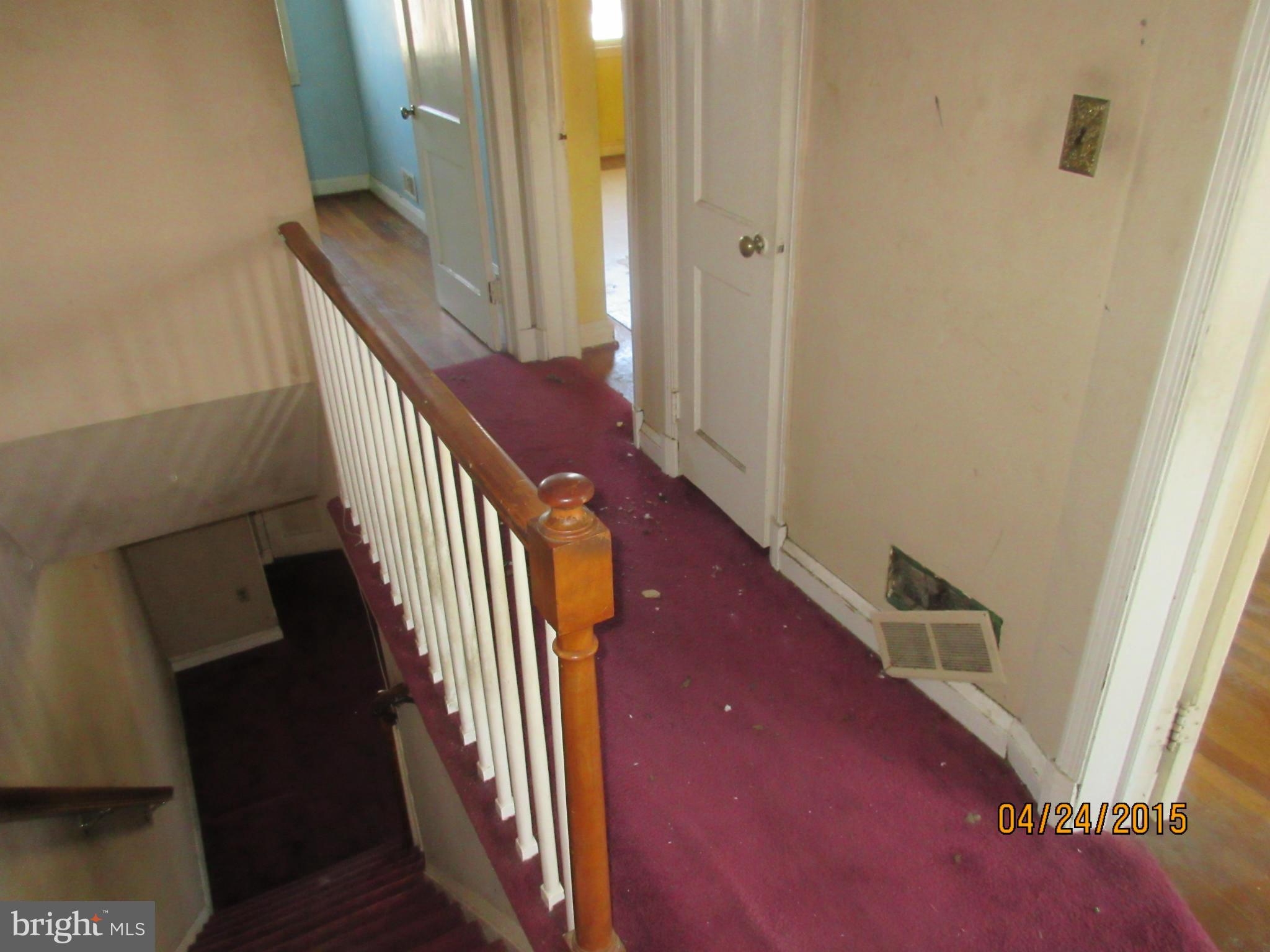 1909 Barry Road Baltimore, MD 21222 - Photo 9 of 12 a view of a hallway with wooden floor and staircase