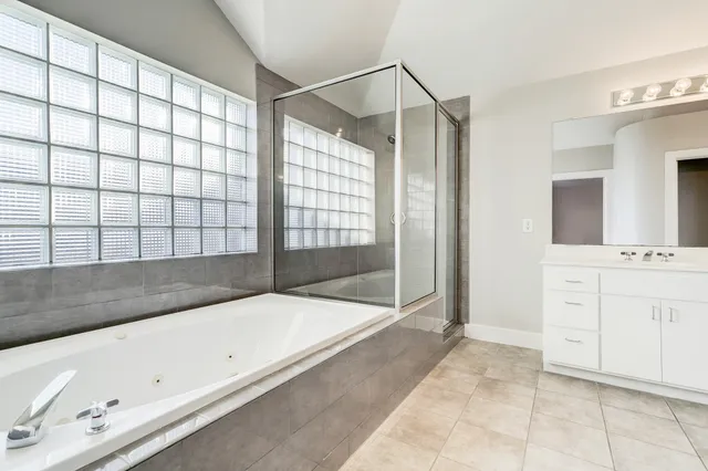 a spacious bathroom with a bathtub and a sink