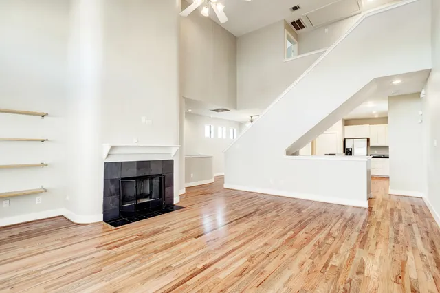a view of empty room with wooden floor and fireplace