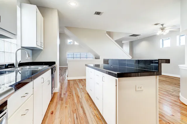 a kitchen with granite countertop a sink and a stove top oven