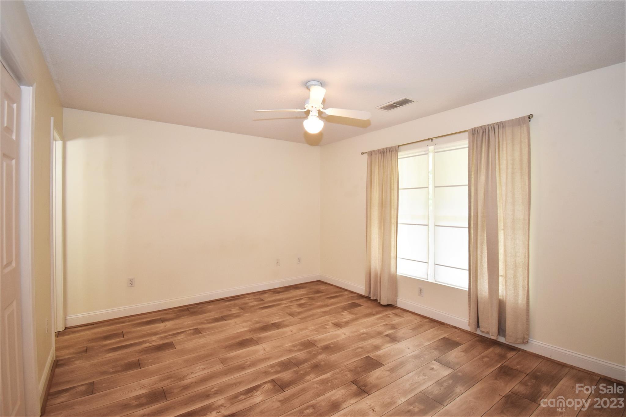 7 Krista Circle, Unit E Candler, NC 28715 - Photo 11 of 24 wooden floor in an empty room with a window
