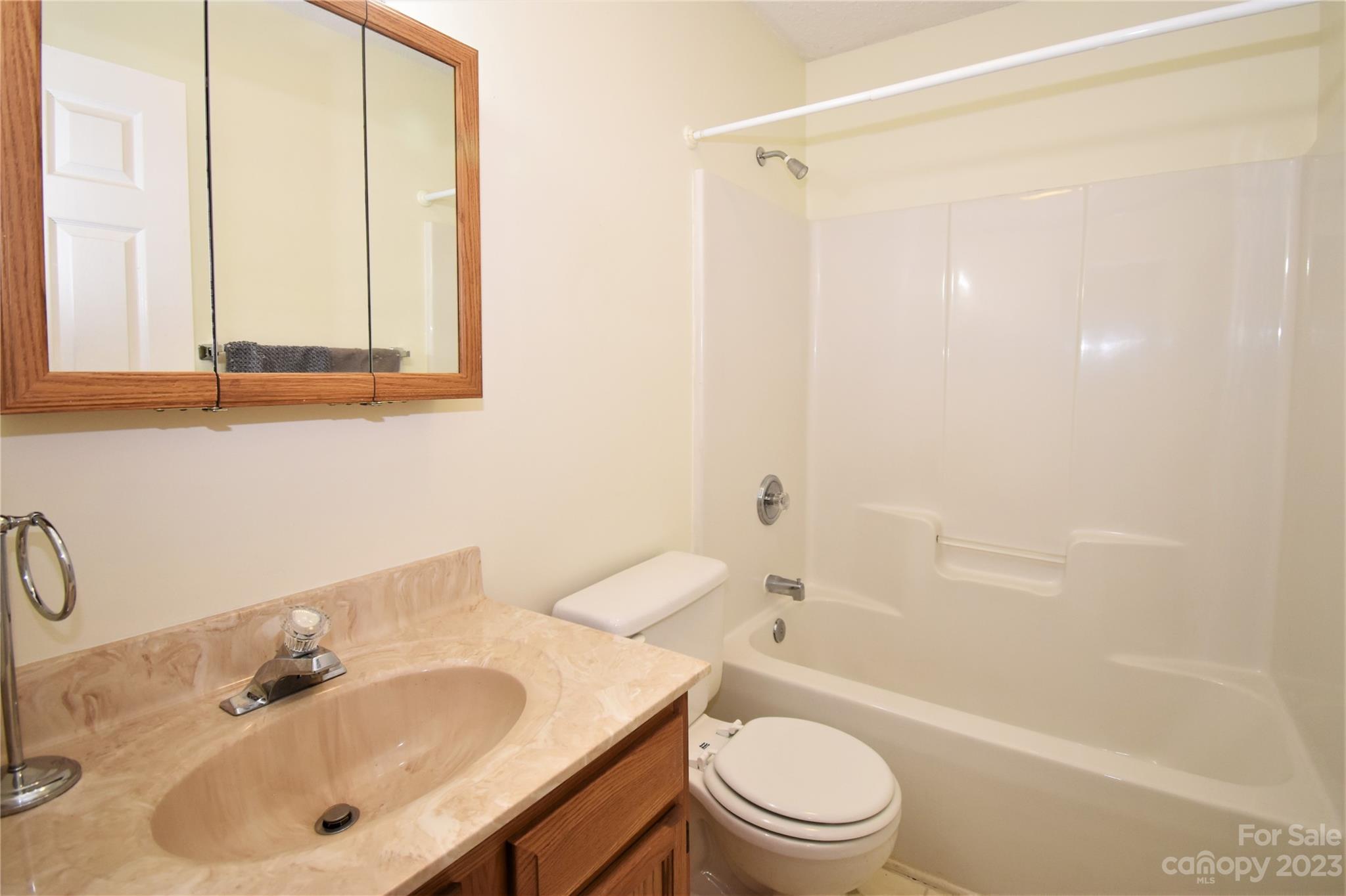 7 Krista Circle, Unit E Candler, NC 28715 - Photo 13 of 24 a bathroom with a sink a toilet and shower