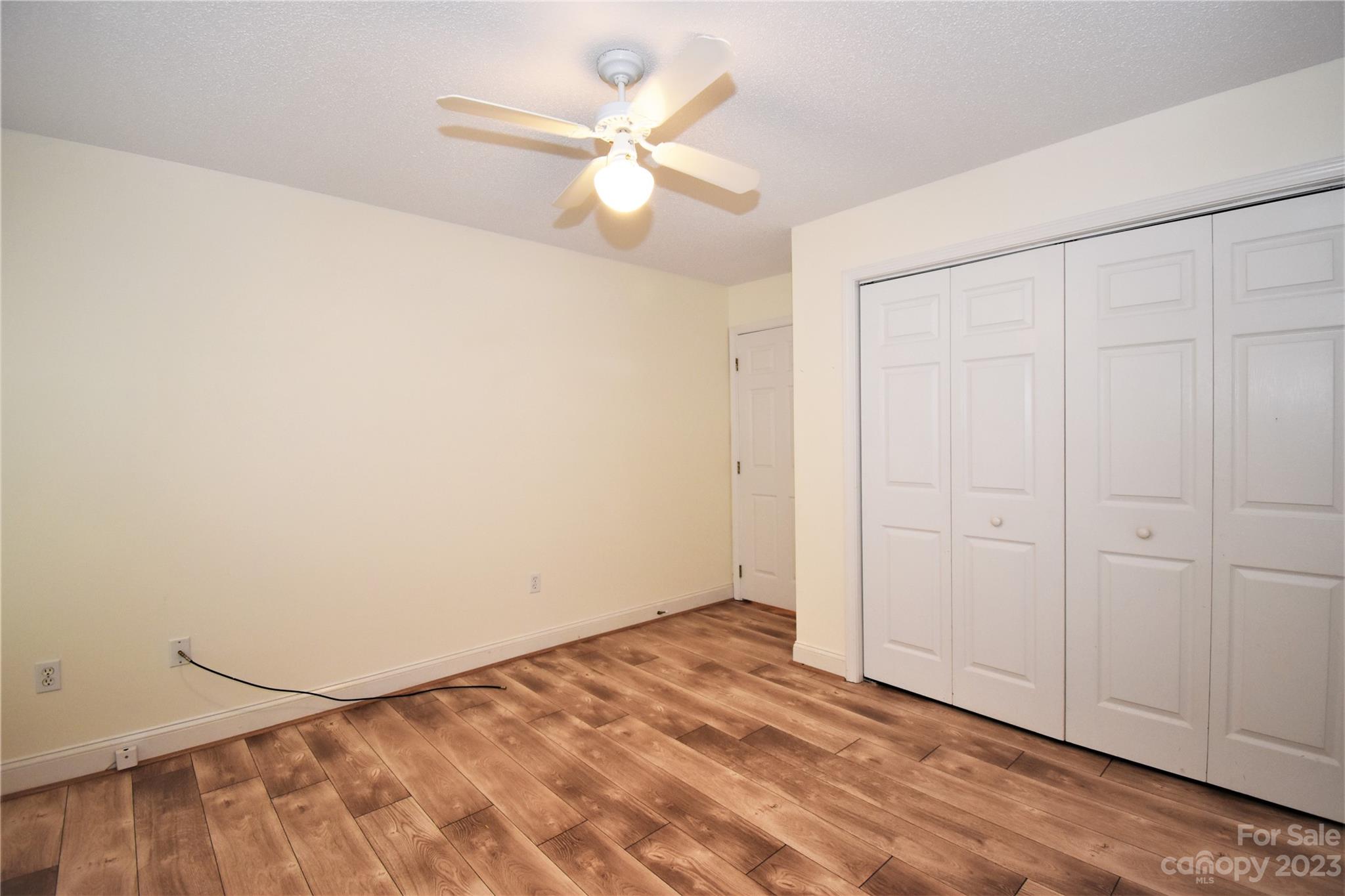 7 Krista Circle, Unit E Candler, NC 28715 - Photo 15 of 24 an empty room with windows and fan