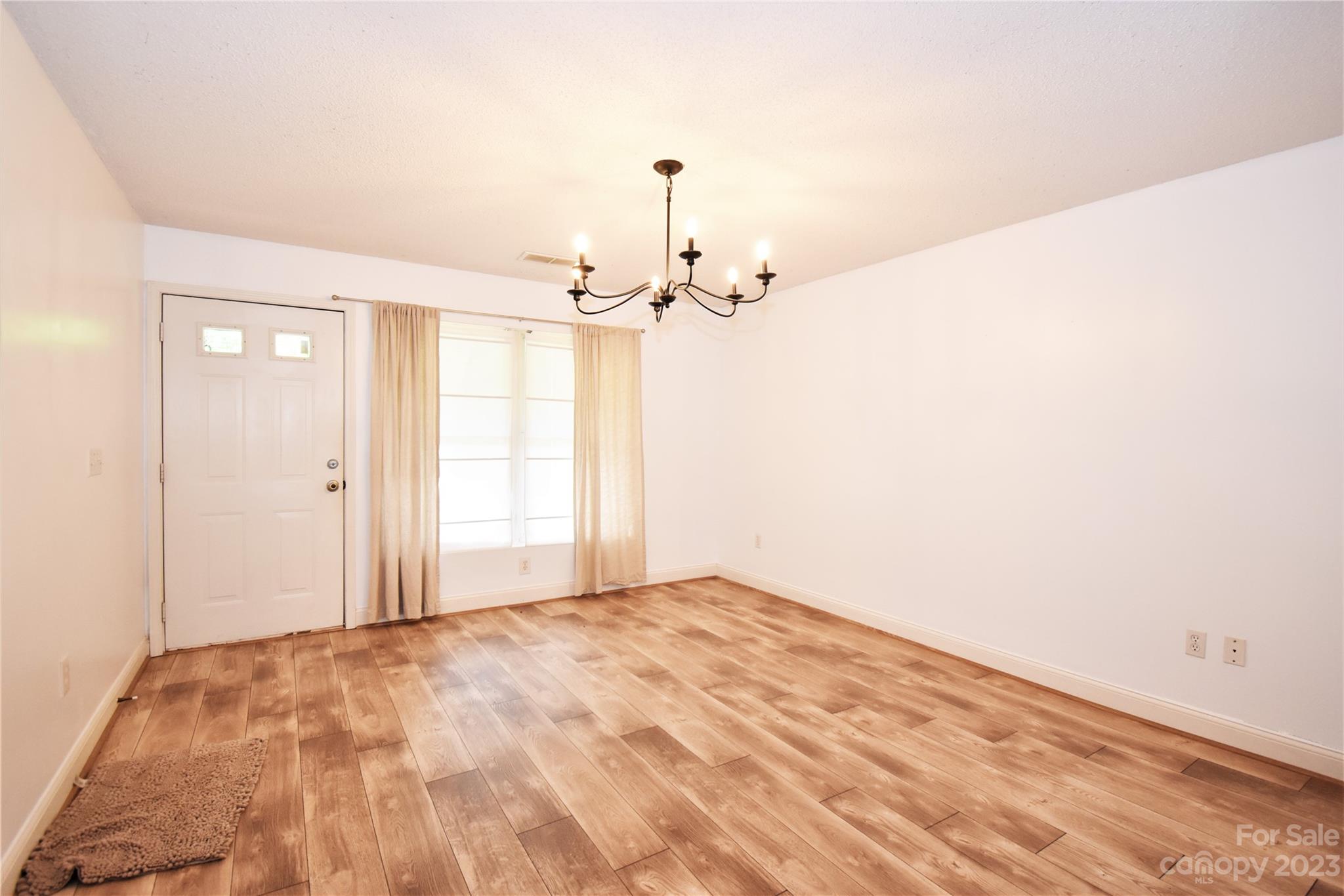 7 Krista Circle, Unit E Candler, NC 28715 - Photo 4 of 24 a view of a bedroom with wooden floor and fan