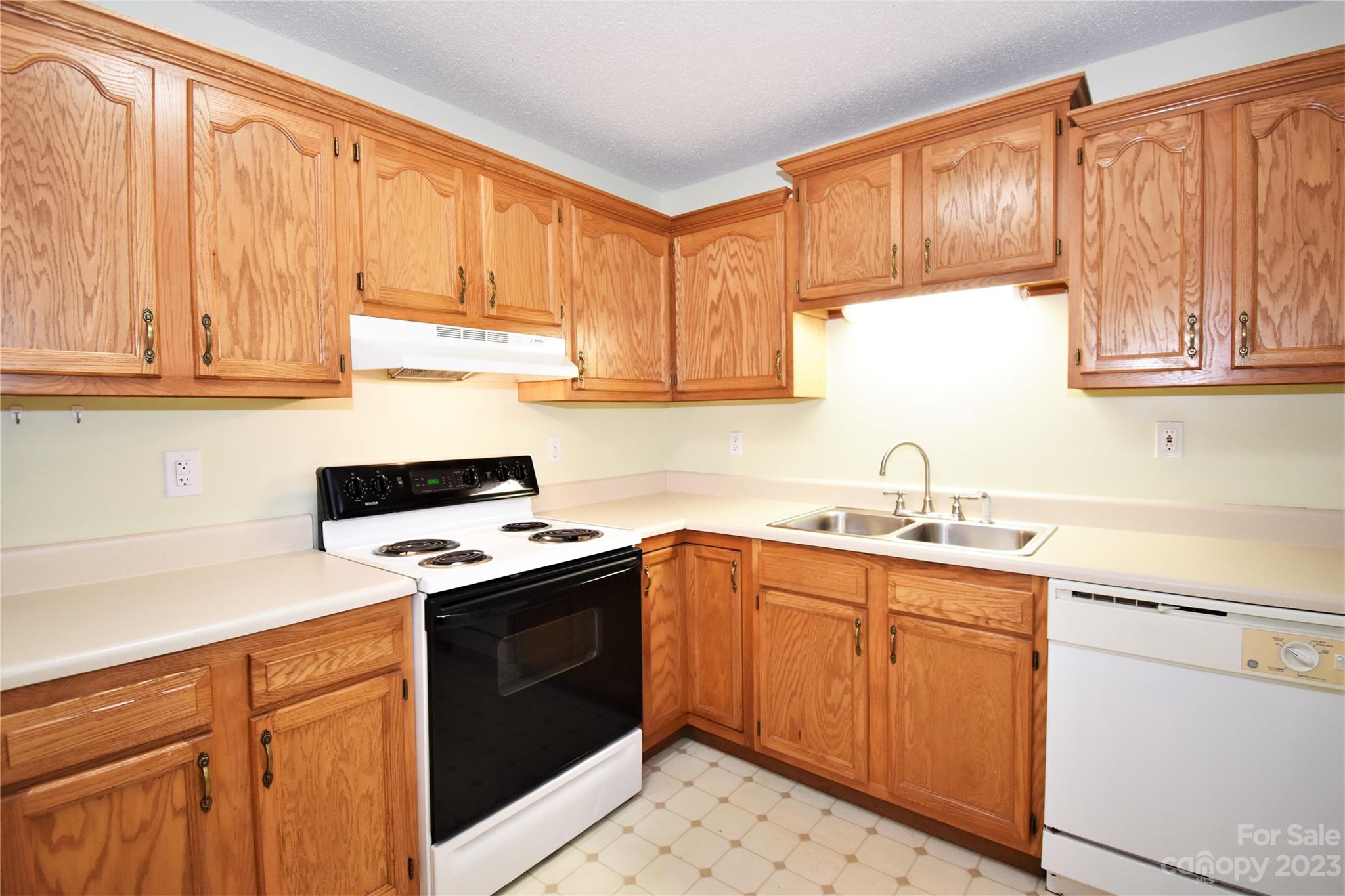 7 Krista Circle, Unit E Candler, NC 28715 - Photo 7 of 24 a kitchen with a sink stove and cabinets