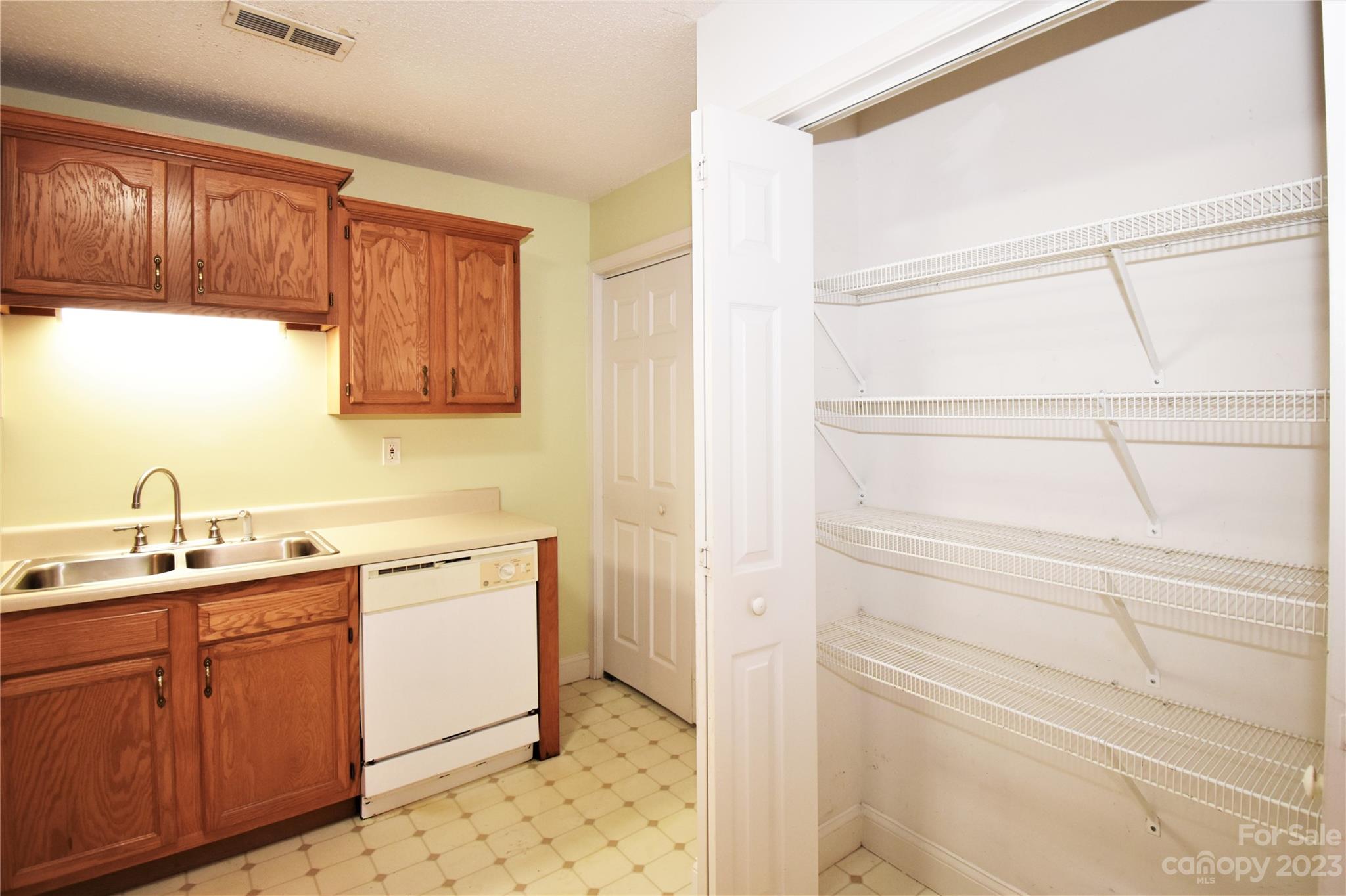 7 Krista Circle, Unit E Candler, NC 28715 - Photo 9 of 24 a kitchen with a sink and cabinets