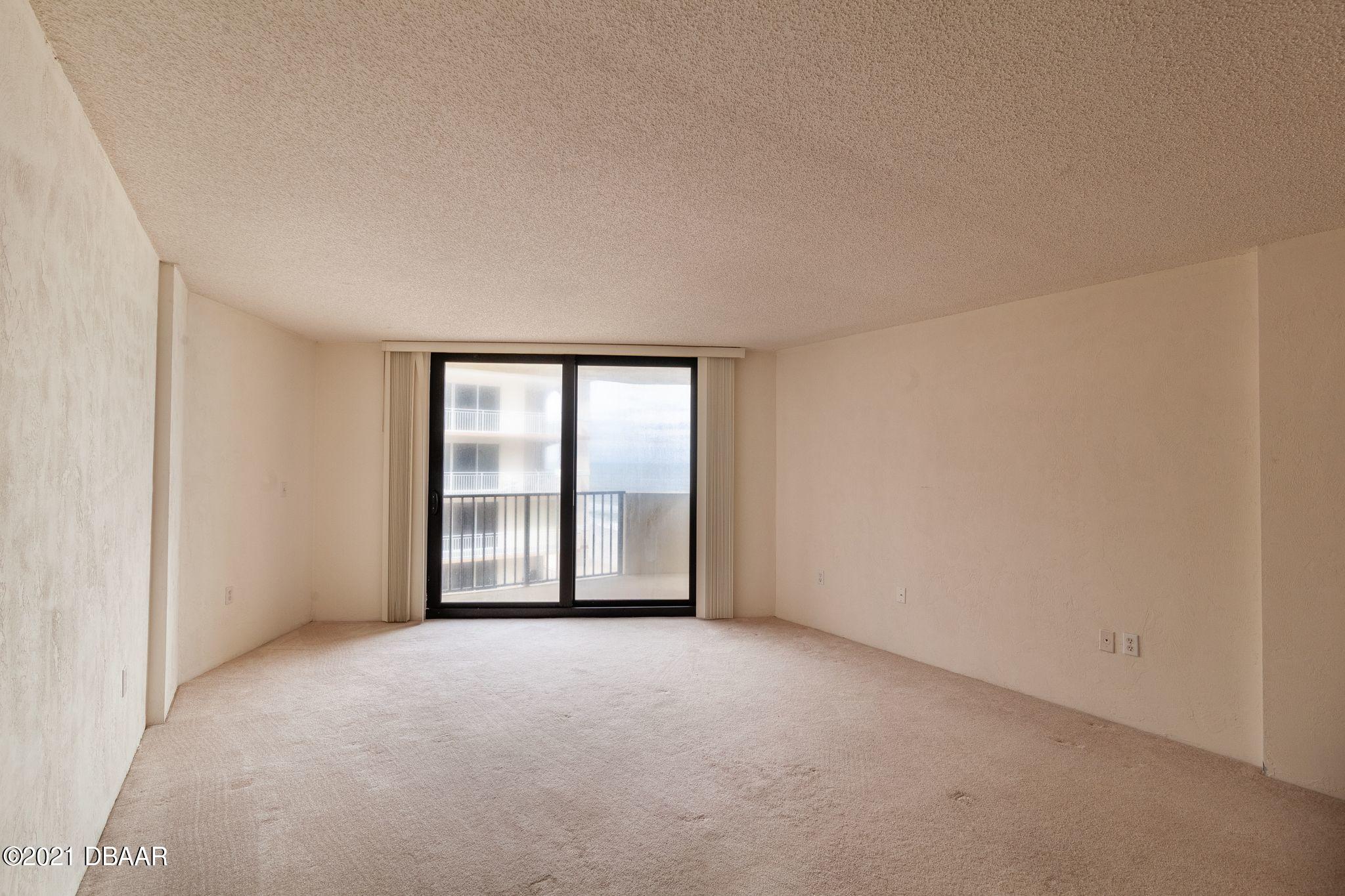 1415 Ocean Shore Boulevard, Unit 903 Ormond Beach, FL 32176 - Photo 12 of 47 a view of an empty room with a window