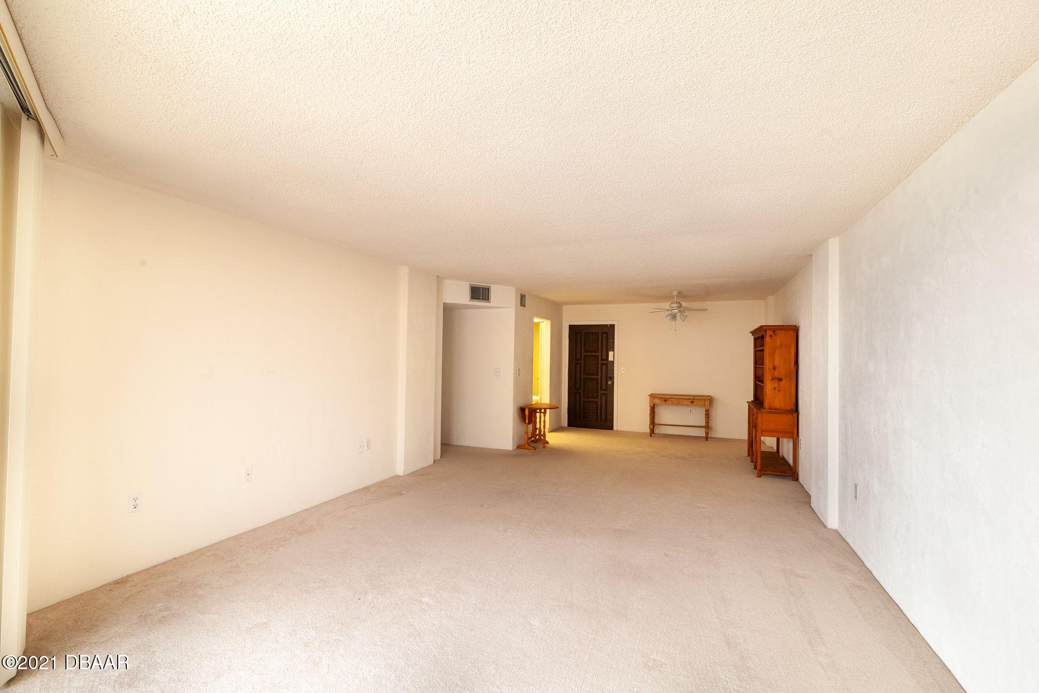 1415 Ocean Shore Boulevard, Unit 903 Ormond Beach, FL 32176 - Photo 13 of 47 an empty room with large window