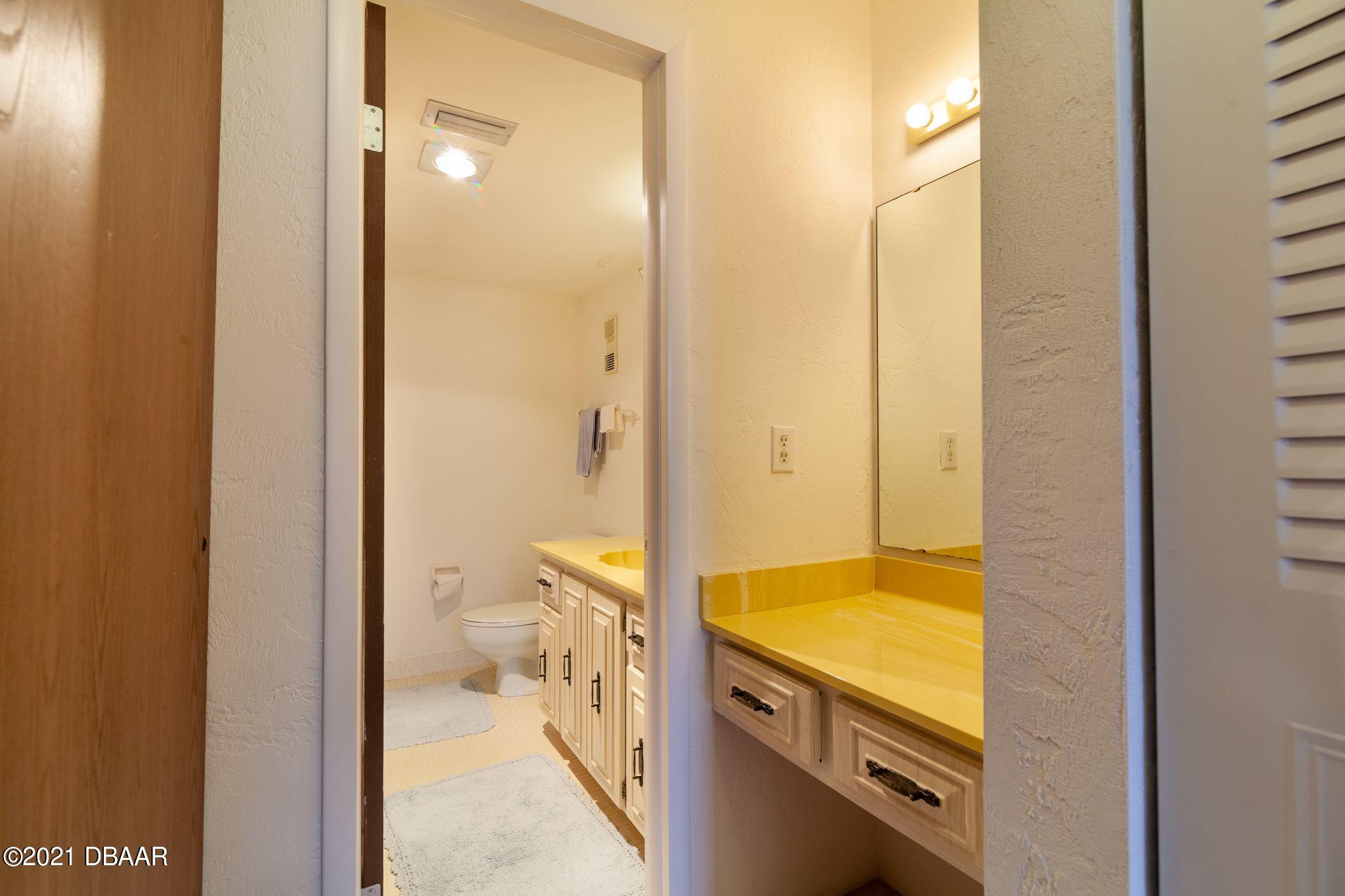 1415 Ocean Shore Boulevard, Unit 903 Ormond Beach, FL 32176 - Photo 19 of 47 a bathroom with a sink a toilet and shower