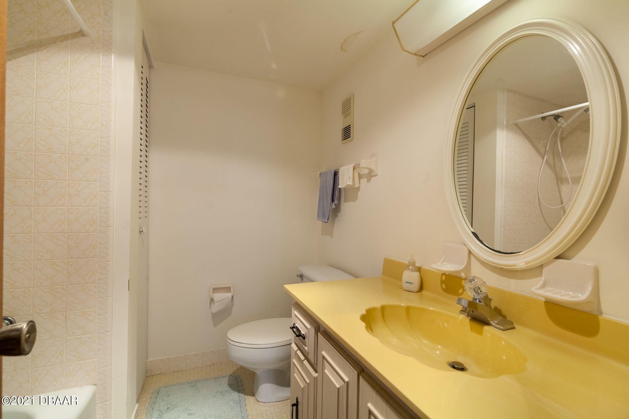 1415 Ocean Shore Boulevard, Unit 903 Ormond Beach, FL 32176 - Photo 20 of 47 a bathroom with a sink and a mirror