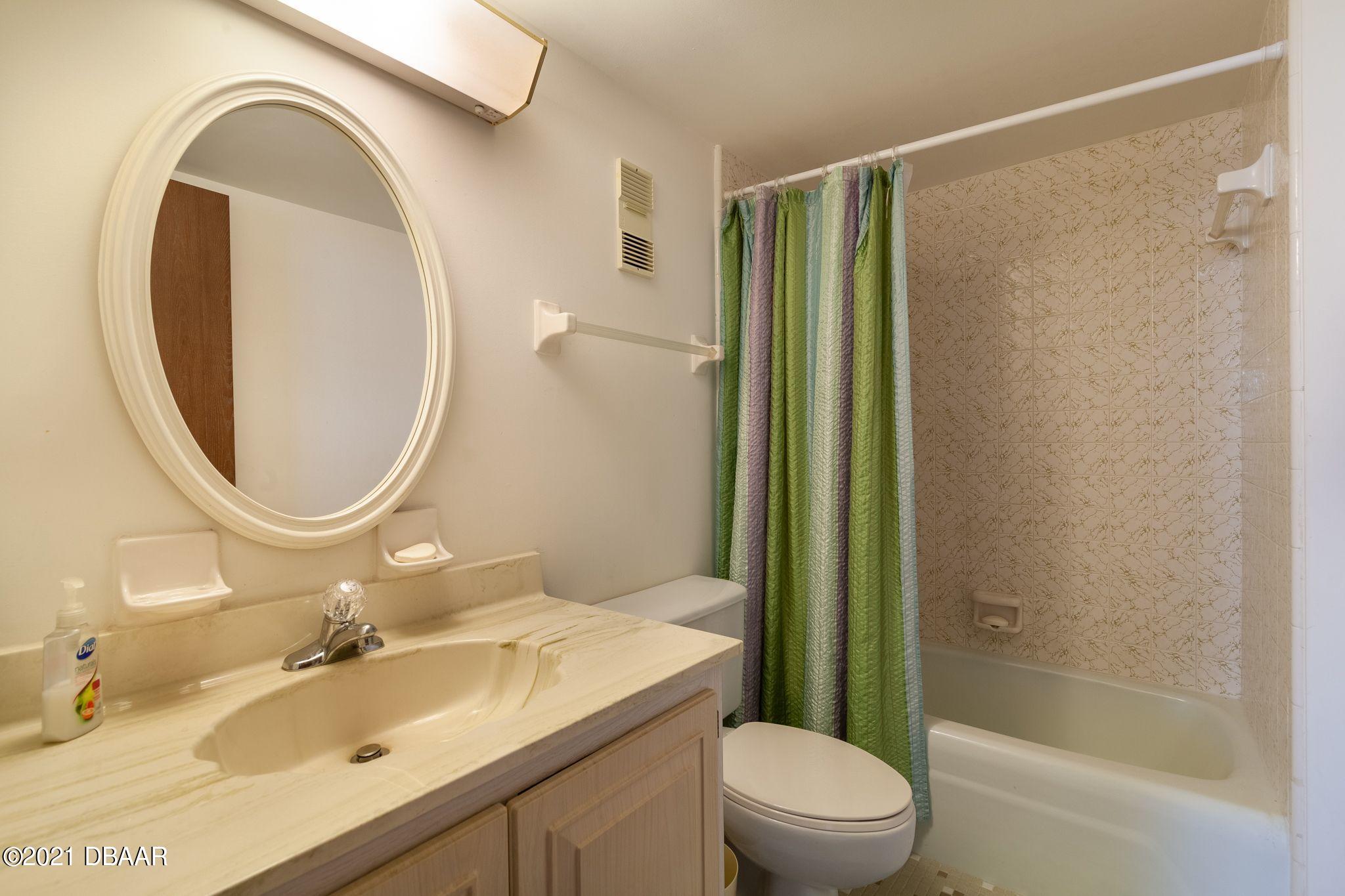 1415 Ocean Shore Boulevard, Unit 903 Ormond Beach, FL 32176 - Photo 21 of 47 a bathroom with a sink toilet and shower