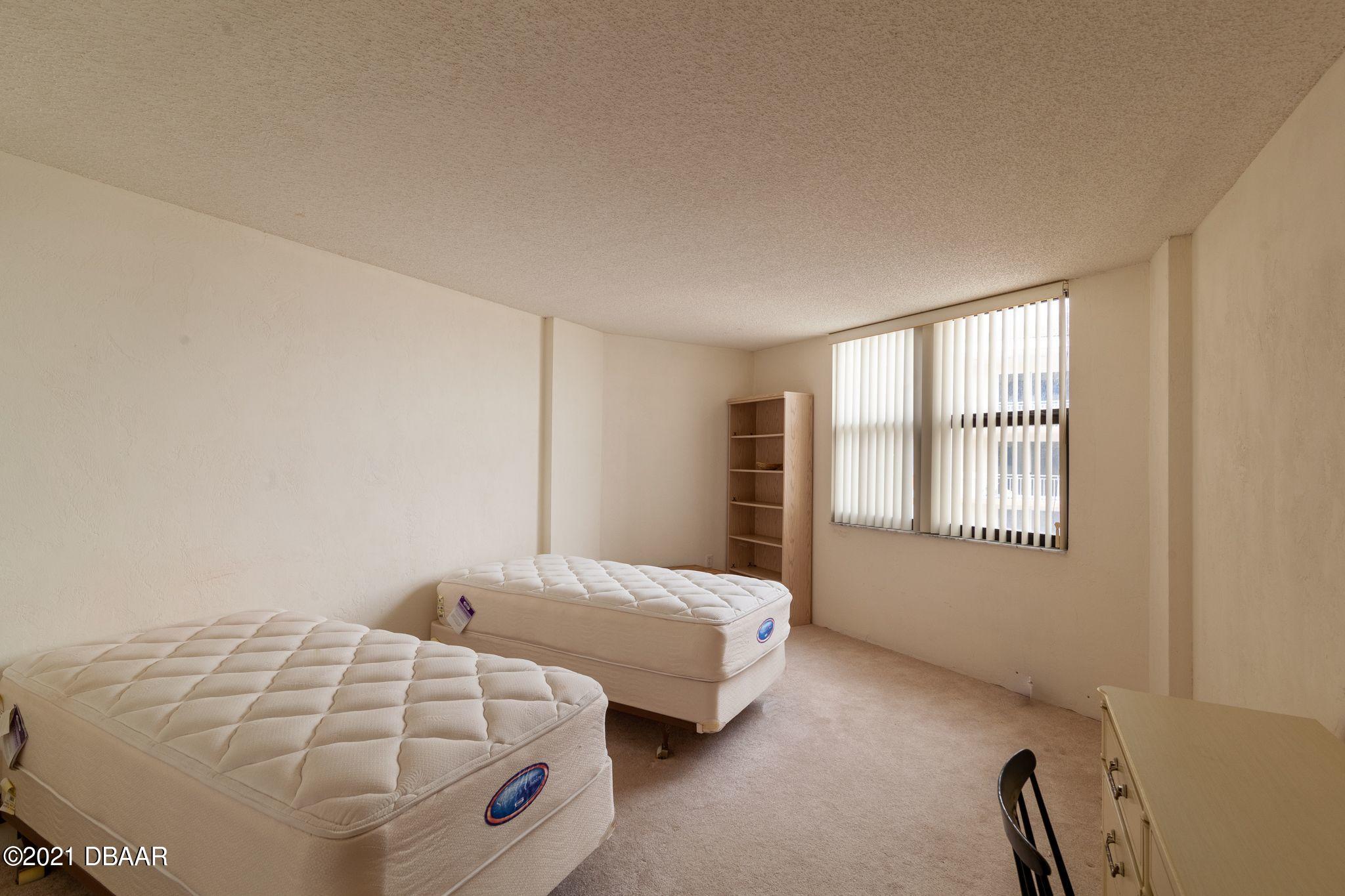1415 Ocean Shore Boulevard, Unit 903 Ormond Beach, FL 32176 - Photo 22 of 47 a bedroom with two beds and a window
