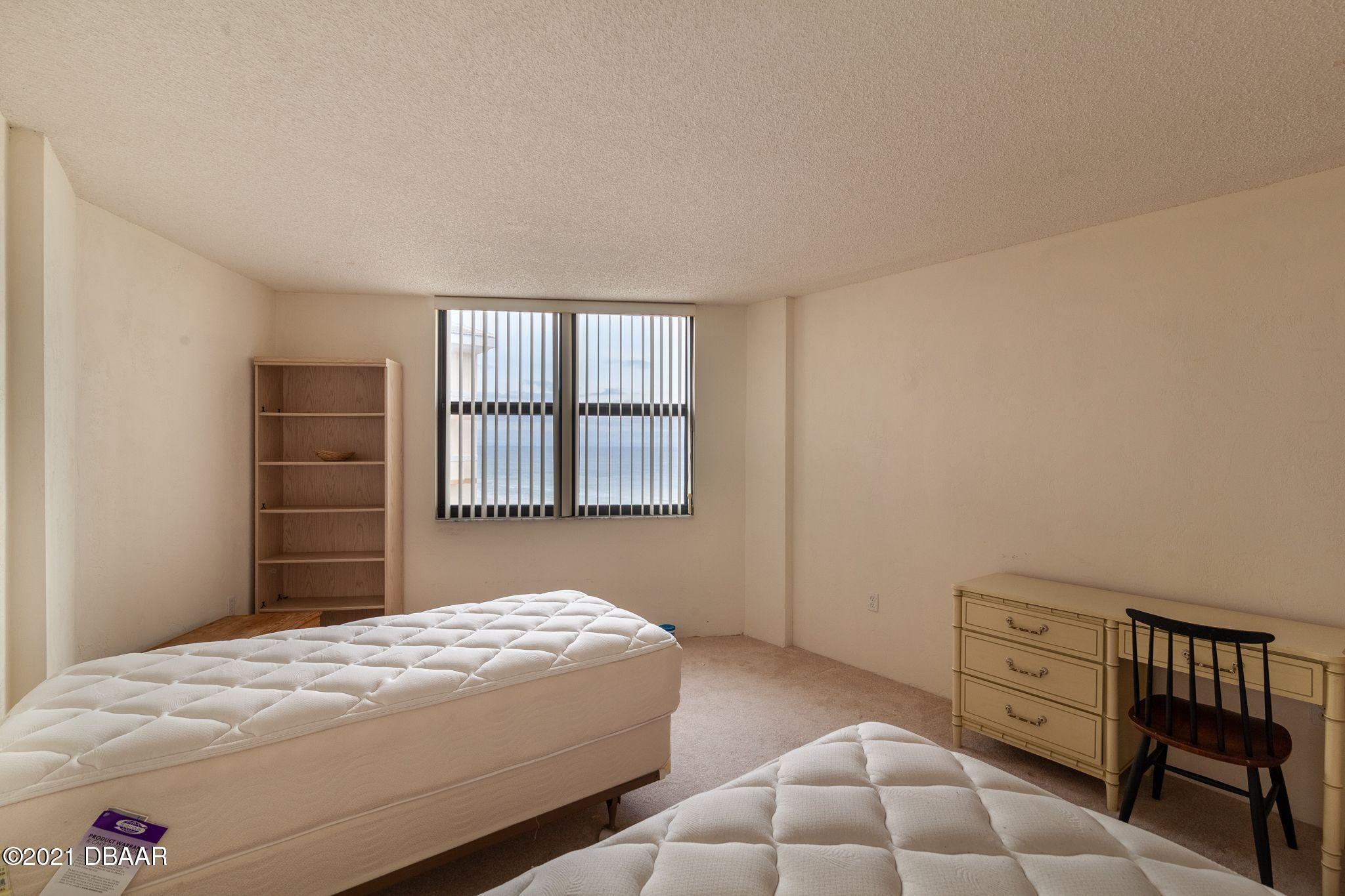 1415 Ocean Shore Boulevard, Unit 903 Ormond Beach, FL 32176 - Photo 23 of 47 a bedroom with a bed and a window