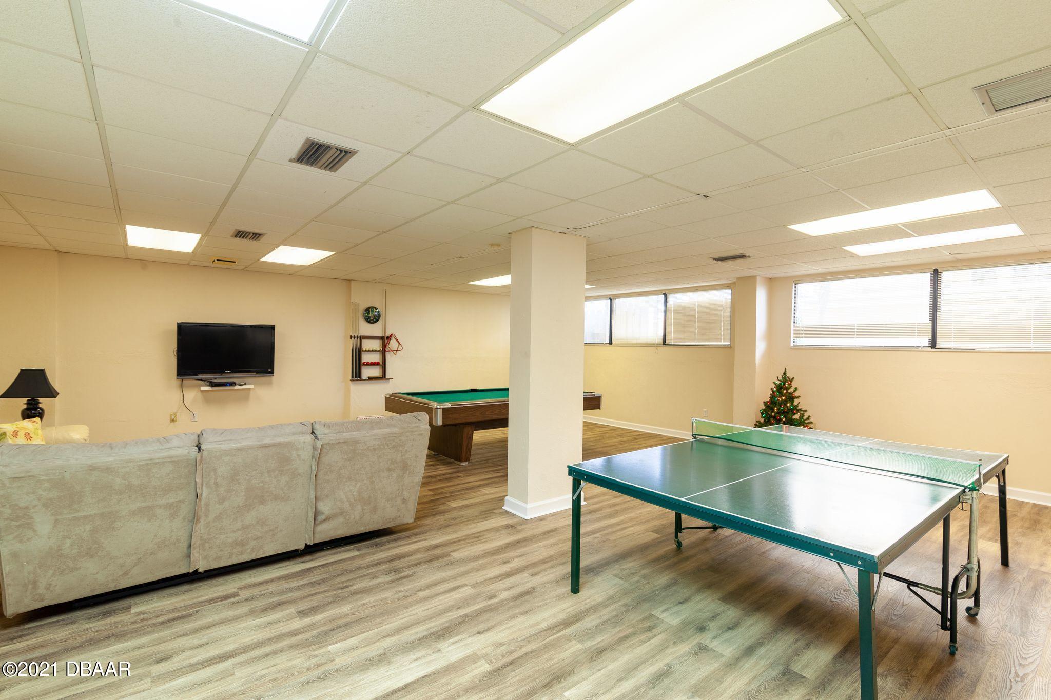 1415 Ocean Shore Boulevard, Unit 903 Ormond Beach, FL 32176 - Photo 36 of 47 a living room with furniture and a flat screen tv