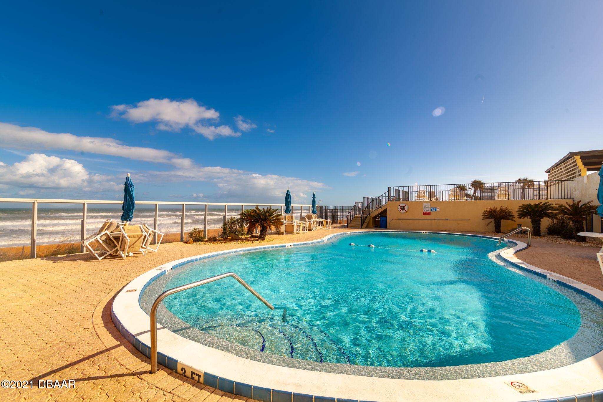 1415 Ocean Shore Boulevard, Unit 903 Ormond Beach, FL 32176 - Photo 46 of 47 a view of a swimming pool with a yard