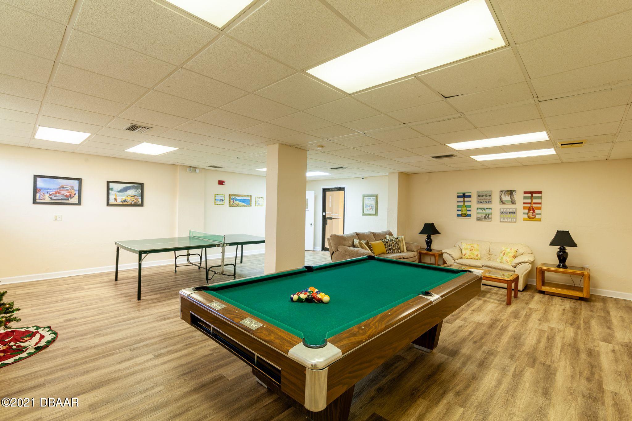 1415 Ocean Shore Boulevard, Unit 903 Ormond Beach, FL 32176 - Photo 7 of 47 a room with pool table and windows