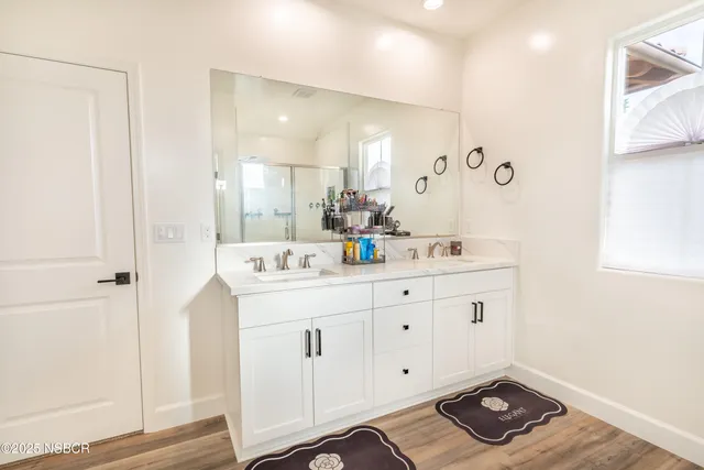 a bathroom with a sink a mirror and a shower