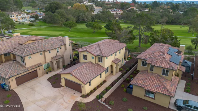 a aerial view of a house with a yard table and chairs