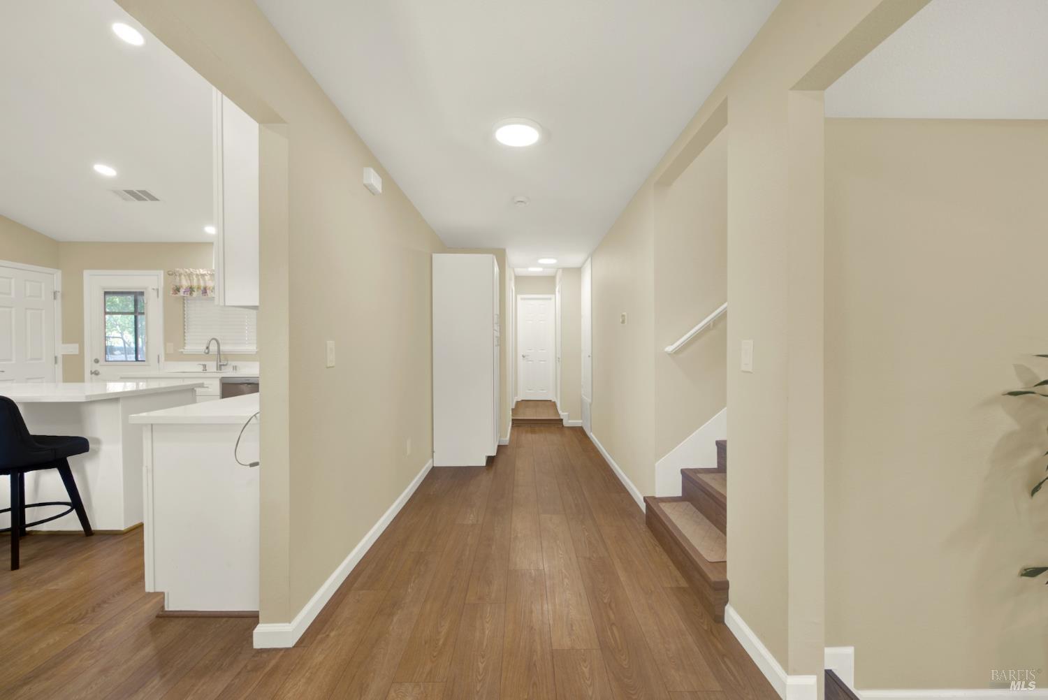 4851 Udell Road Vacaville, CA 95688 - Photo 14 of 65 a view of a hallway with wooden floor and a bathroom