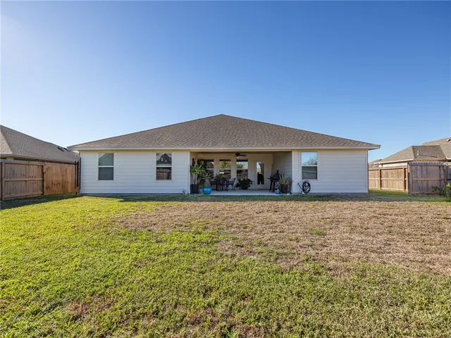 a dining room with furniture and a potted plant